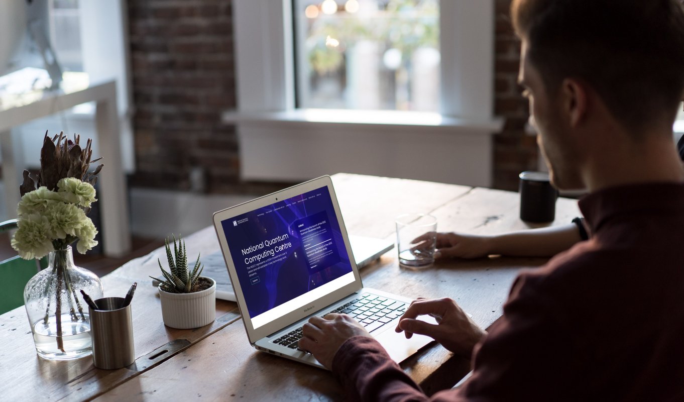 Laptop displaying homepage of National Quantum Computing Centre (NQCC) B2B web design, built bespoke and responsive on Wordpress CMS