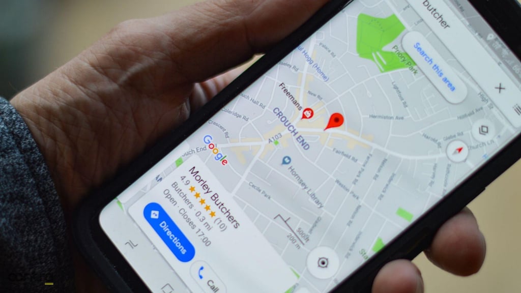 Mobile phone displaying local business' Google reviews