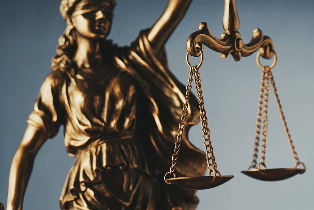 igure of Justice holding the scales of justice - law firm marketing image